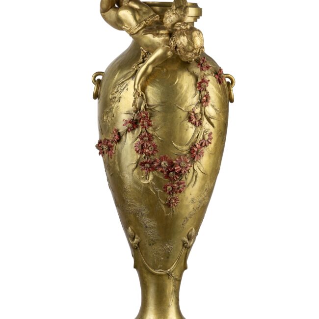 bronze vase with a cupid and red flowers